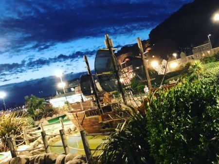 Hastings Adventure golf Pirate boats lit up at night