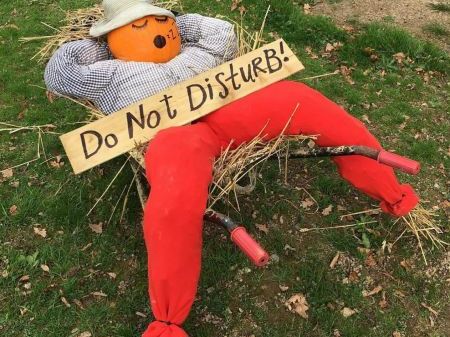 Pumpkin Person in pile of hay with do not disturb sign
