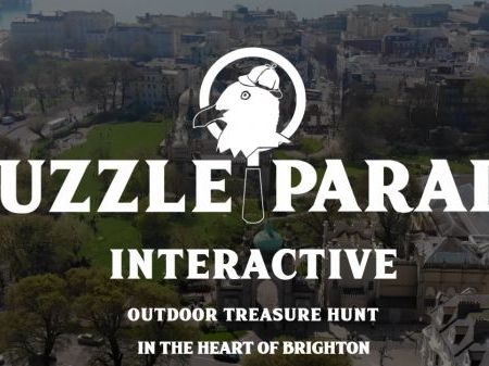 Puzzle Parade Branding with Brighton Landscape, White wording in front of Brighton houses.
