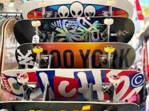 6 skateboards on rack with their designs showing.