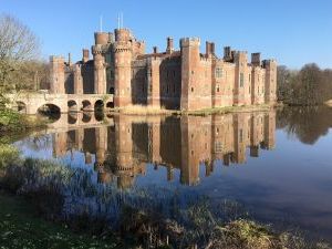 Herstmonceux castle and it's reflection in still moat water