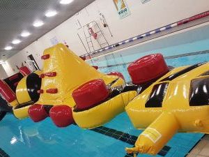 Giant inflatable assault course floating in a pool