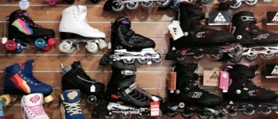 A wall in the store 7 ply that is full of skates, all different colours and sizes.