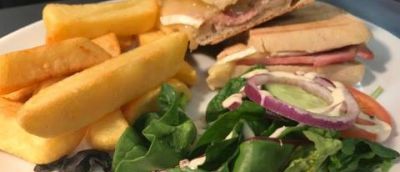 A lunch which includes salad chips and a toastie