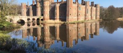 Herstmonceux castle and it's reflection in still moat water