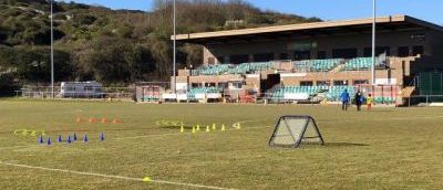 A football pitch with cones and football training equipment