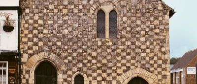 Front of museum building, cream and brown bricks.